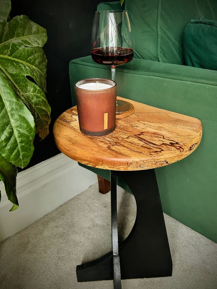 Small handmade wooden side table made from oak and spalted beech with candle and glass of wine on it