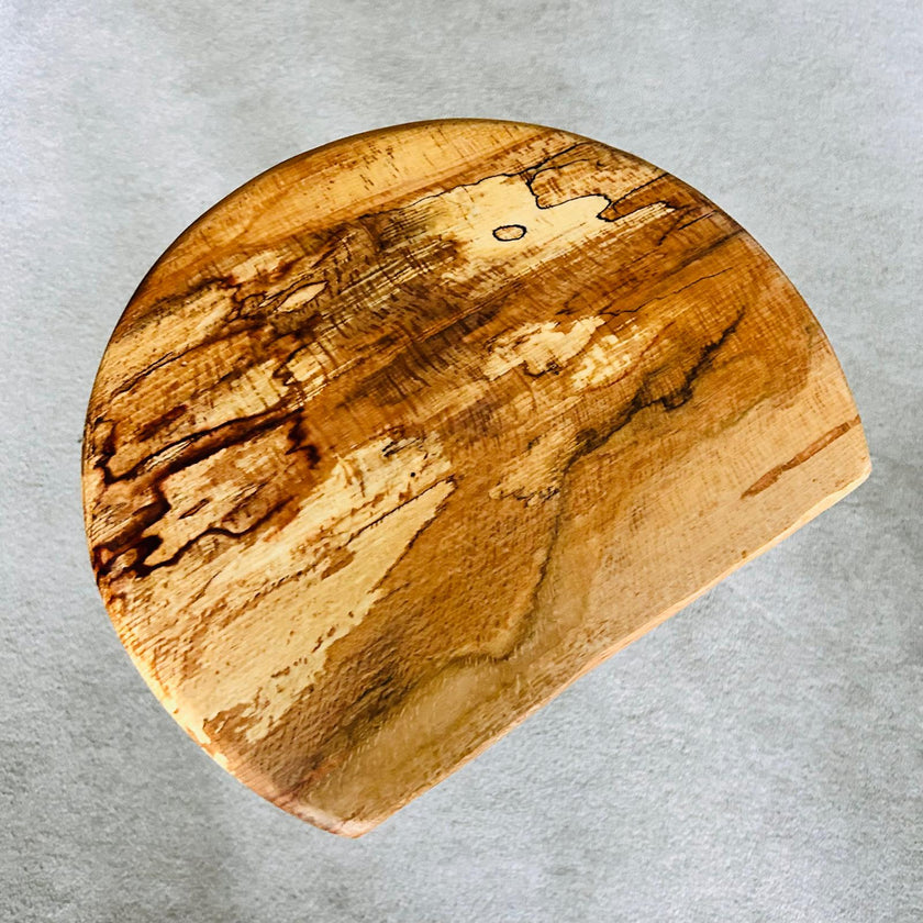 Small handmade wooden side table made from spalted beech and oak  with a natural grain pattern on a gray background