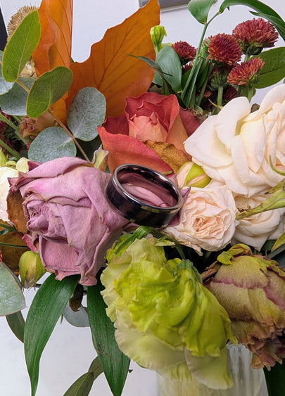Bouquet of flowers with a handmade wood ring on top
